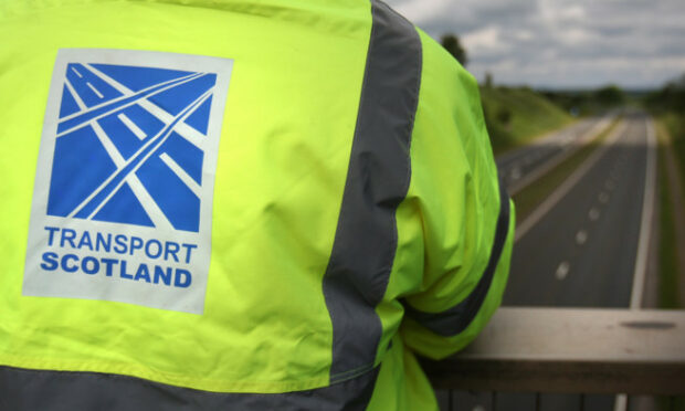 Kris Miller, Courier, 26/06/12. Picture today at A9 flyover at Luncarty for announcement about A9 dualling to start 2 years earlier than planned. Pic shows a member of Transport Scotland looking at a section of the A9 which narrows from two lanes to one. For Files.