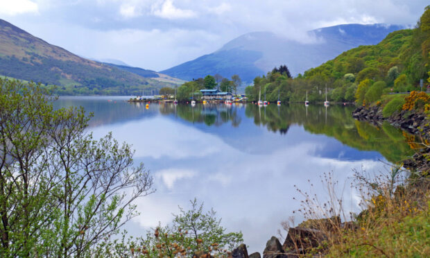 Image shows Loch Earn with mountains in the background