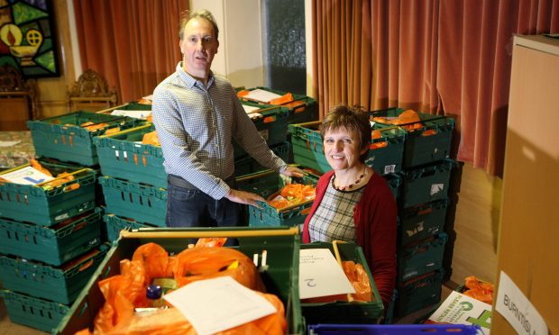 Fife councillor Judy Hamilton and Kirkcaldy Foodbank chairman Ian Campbell, chairman of Kirkcaldy foodbank, preparing deliveries for service users.