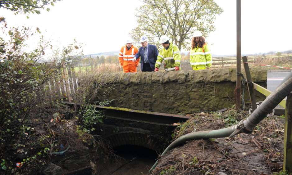 David McDiarmid, second left, surveys a culvert in 2016 during the fight for a Freuchie Mills flooding scheme. 