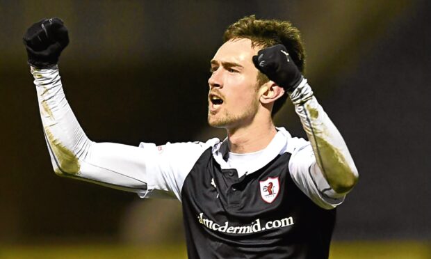 Ryan Hardie raises two clenched fists in celebration.