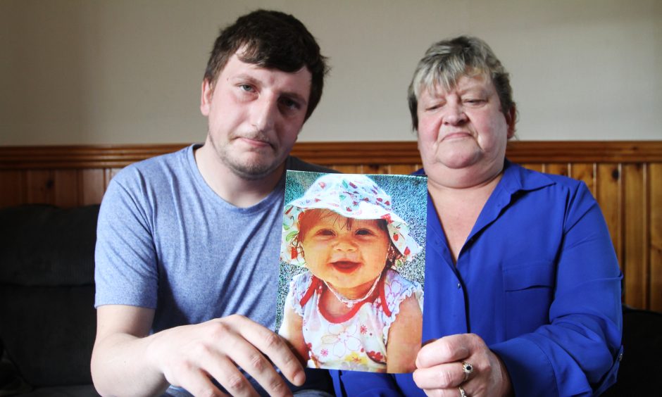 Left to right: Thomas Haldane with mum Alexis Munro holding a picture of murdered toddler Madison Horn.