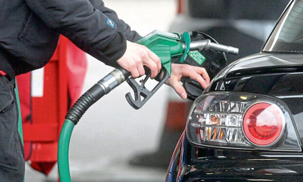 Undated file photo of driver putting petrol in a car. See PA Feature MOTORING Column. Picture credit should read: PA. WARNING: This picture must only be used to accompany PA Feature MOTORING Column.