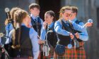 Lochgelly High School Pipe Band warm up at a previous event. Image: Steve MacDougally/DC Thomson