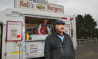 Cheeseburger tycoon Bob Servant outside his burger van.