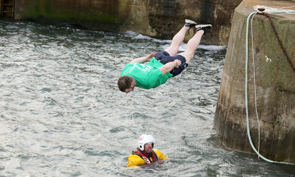 A hardy participant jumps of Anstruther pier during the East Neuk Dook