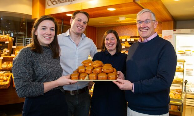 From left: Jade, Ben, Chloe and Eric Milne with a tray of their famous fudge donuts in 2019.