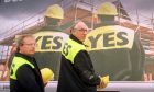 Donald Dewar and Fife's Henry McLeish in front of Yes to Devolution billboards in Glasgow 1997.