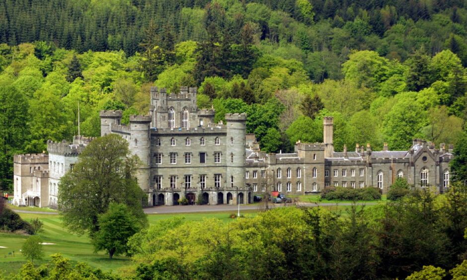 Taymouth Castle, Kenmore, surrounded by trees and hills.
