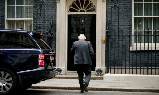 Boris Johnson enters 10 Downing Street.