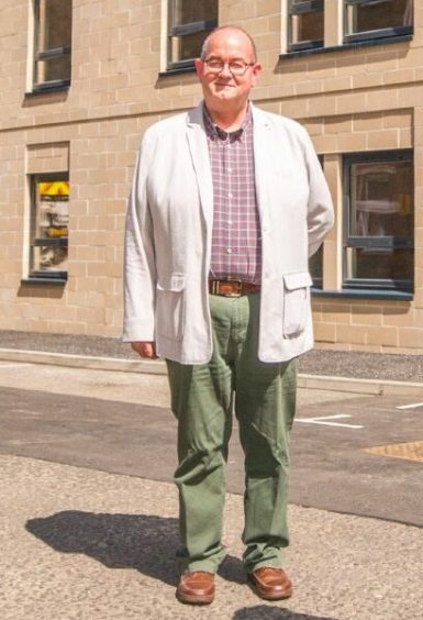 Bob Brawn standing in street in more casual clothes