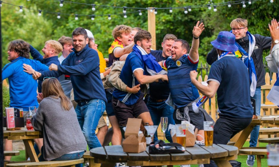 Scotland football fans celebrating in the beer garden at the Cherrybank Inn 