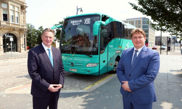 McGill's chairman James Easdale ( light blue suit) & his brother Sandy with the Dundee to Edinburgh airport bus.