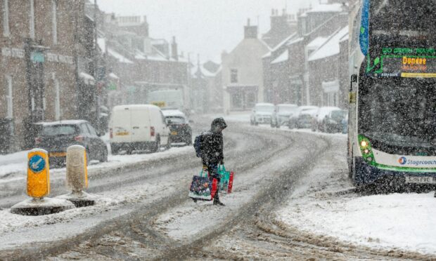 A child crossing a road in a transport review 2021 article