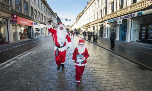 People in Santa outfits taking part in the Dundee Santa Dash