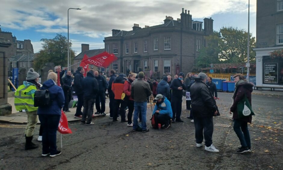 The striking Dundee University workers outside of the university gates on Monday morning.