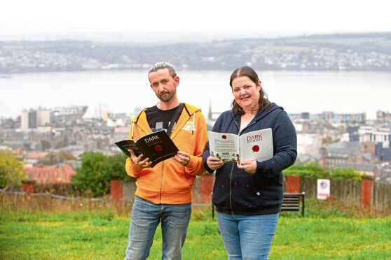Louise Murphy and Stewart Heaton of Dark Dundee at Dundee Law with their books about the dark history of Dundee.
