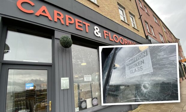General view of Carpet and Flooring Store with, inset, a cracked window