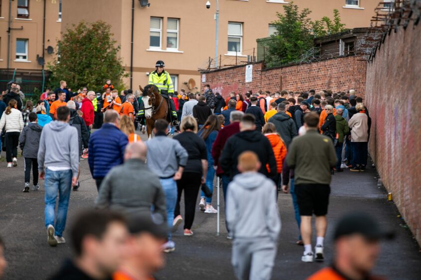 Fans walking to Tannadice Park in Dundee