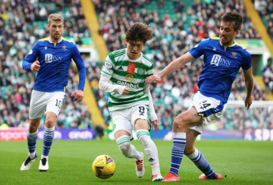 Celtic's Kyogo Furuhashi is tackled by Callum Booth.