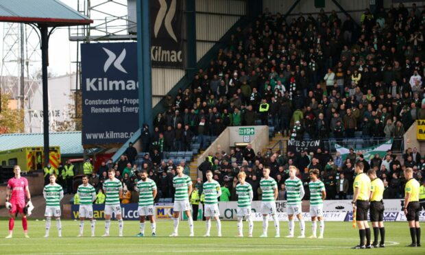 Celtic players observing a minute silence during the cinch Premiership match between Dundee and Celtic at the Kilmac Stadium at Dens Park.