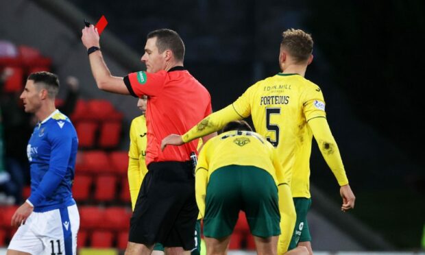 Referee Euan Anderson shows a red card to Craig Bryson.