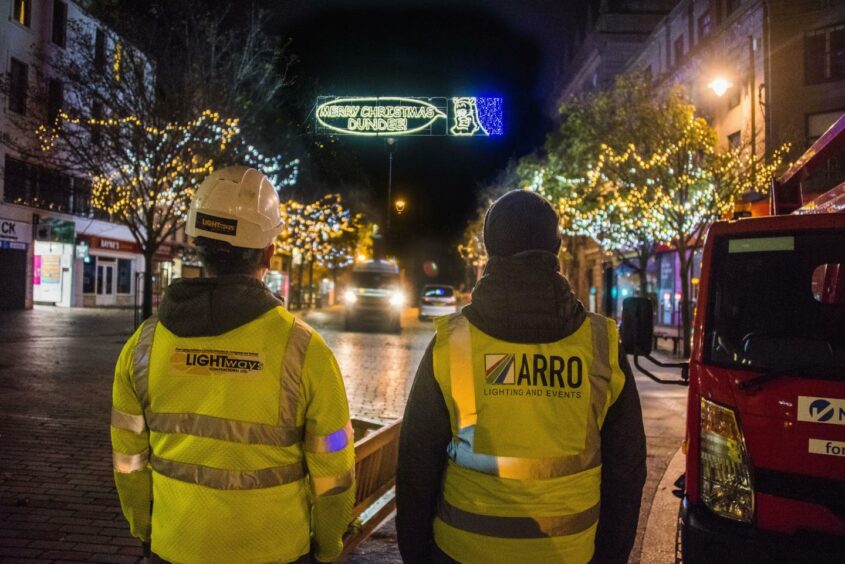 Workers looking at the new Christmas lights in Dundee