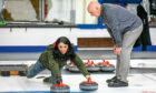 Coach Pete Walls gives Gayle Ritchie a curling lesson. Picture: Steve Brown.