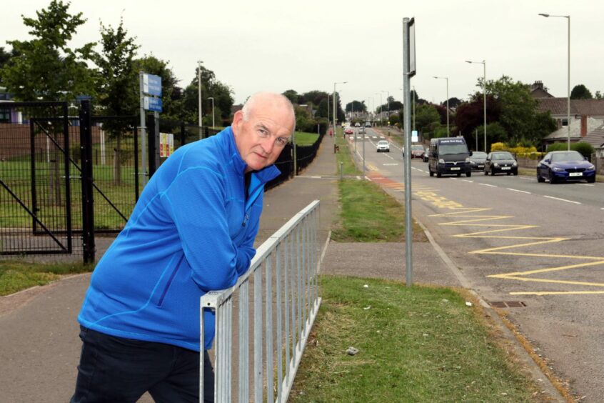 Councillor Kevin Keenan leaning over a railing in Dundee