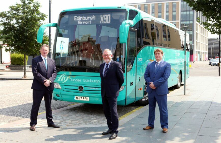 McGills buses chairman James Easdale, his brother Sandy with the Dundee to Eduinburgh airport bus and CEO of McGills Group , Ralph Roberts in the centre.