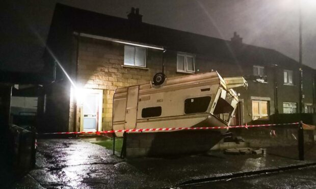 The caravan landed on its roof in a garden in Douglas, Dundee.