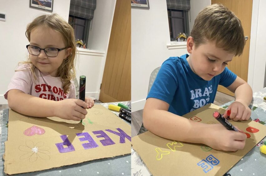 Siblings Faith and Patrick Donnelly making signs for the Reclaim the Night protest.
