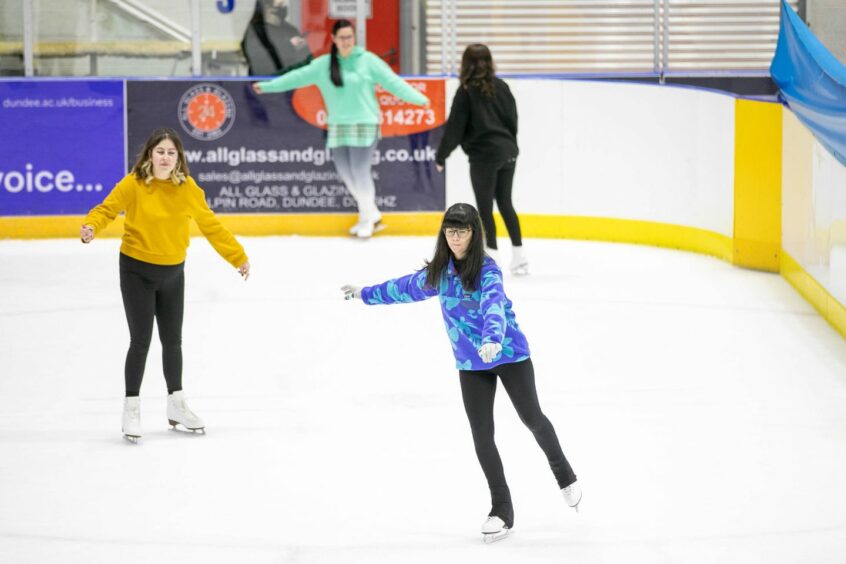 Tara Jones (far left) and other intermediate skaters at the adult ice skating class.