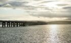 A man and his dog were rescued from mud close to the Tay Bridge.