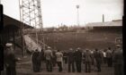 Fans gather at the Provost Road end of at Dens Park in 1960.
