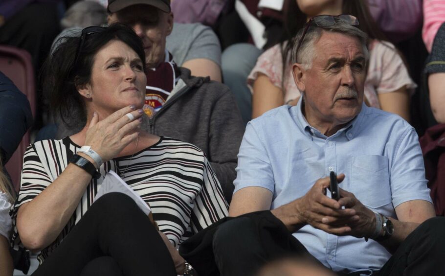 Heather and Jack watch John playing for Hearts.