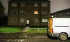 A police forensics van outside the block of flats on Aboyne Avenue.