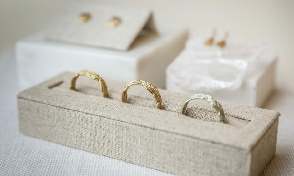 Three gold rings made from thin metal wires, giving them a lined texture.