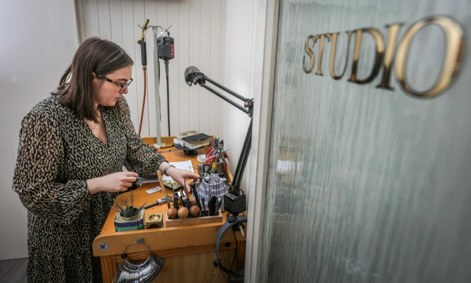 Elizabeth Humble in her studio next to her workbench where she creates her jewellery.