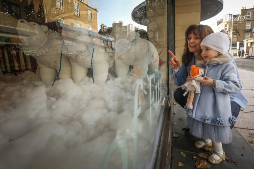 Sofia Bertolotto, two, and mum Gemma look through the window at the display.