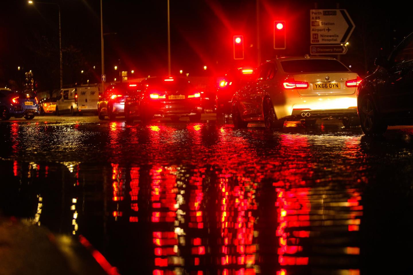 Cars drive through flood water