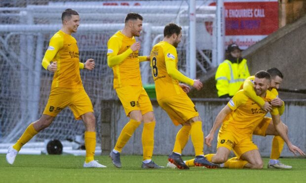 Taylor-Sinclair celebrates a goal against Motherwell