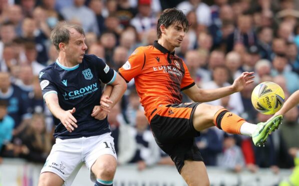 Dundee's Paul McGowan and Dundee United's Ian Harkes battle for possession the last Dundee derby