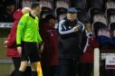 Arbroath manager Dick Campbell speaks to the linesman during the clash with Raith Rovers at Gayfield.