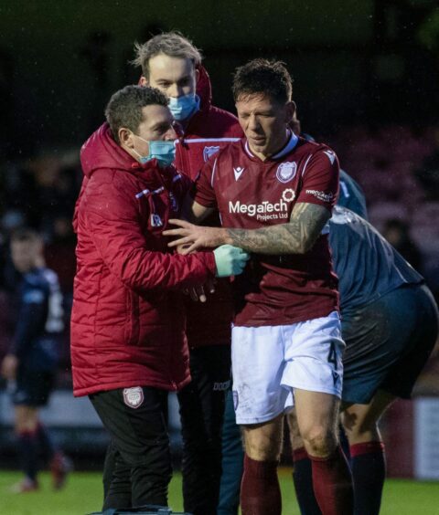 Ricky Little refuses treatment from the Arbroath medical team after the head clash with Christophe Berra.