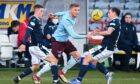 Hearts' Taylor Moore is pressured by Dundee's Luke McCowan and Paul McGowan.