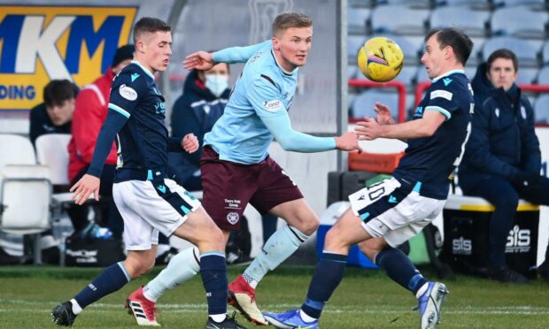 Hearts' Taylor Moore is pressured by Dundee's Luke McCowan and Paul McGowan.