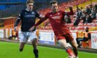 Aberdeen's Marley Watkins and Dundee's Luke McCowan in action at Pittodrie.