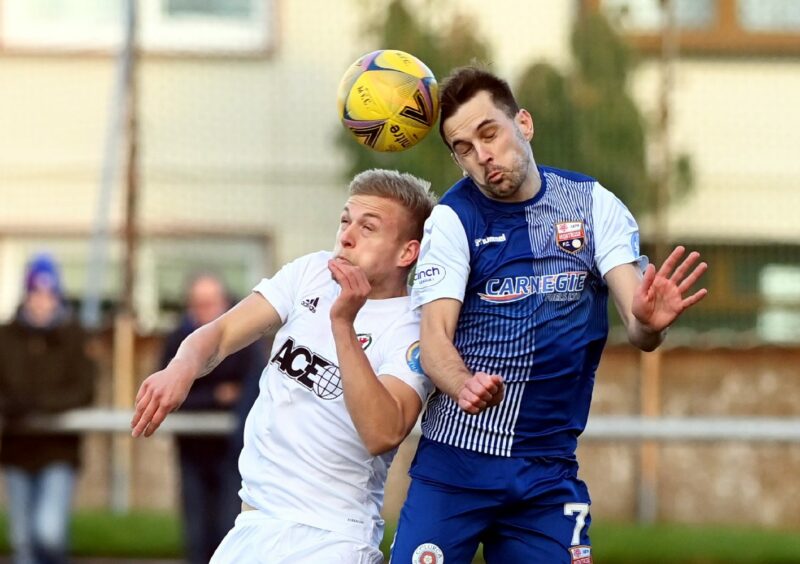 Graham Webster wins a header against Cove Rangers' Harry Milne earlier in the season.