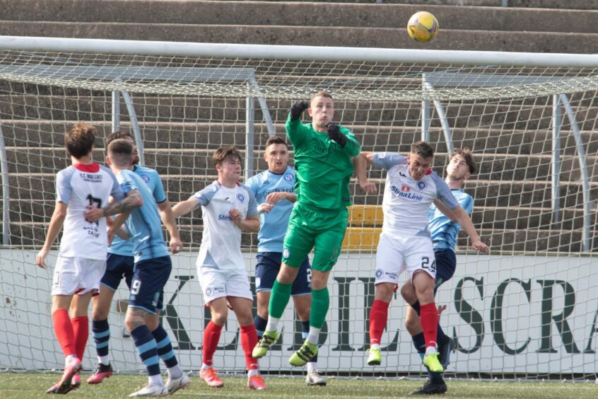 Marc McCallum punches clear during a game at Station Park earlier in the season.